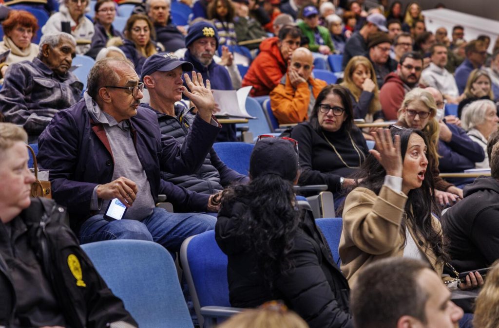 Palisades fire victims vent frustration as town hall on debris removal becomes a free-for-all